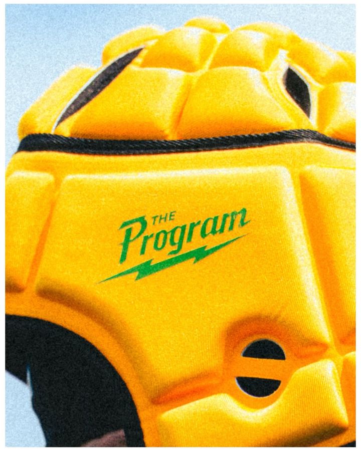 Yellow Program padded headgear with the green lightning wordmark