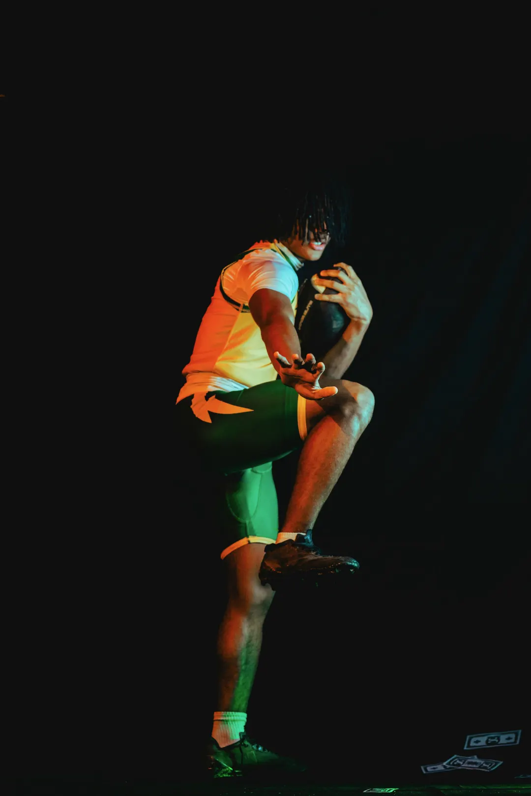 Program athlete number 3 hitting a double-biceps flex in the gold jersey