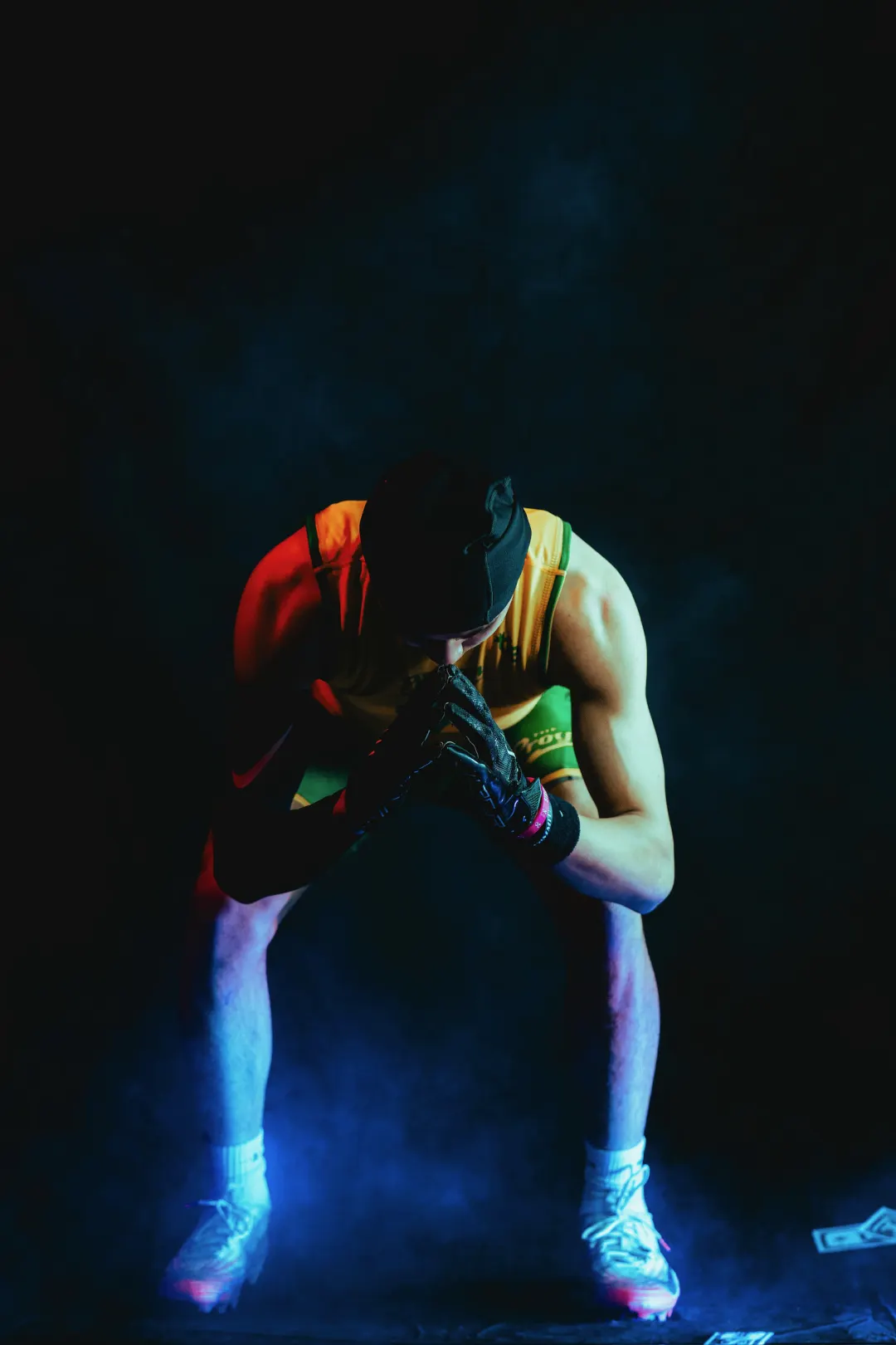Program athlete in a black beanie crouched toward the camera, hands together