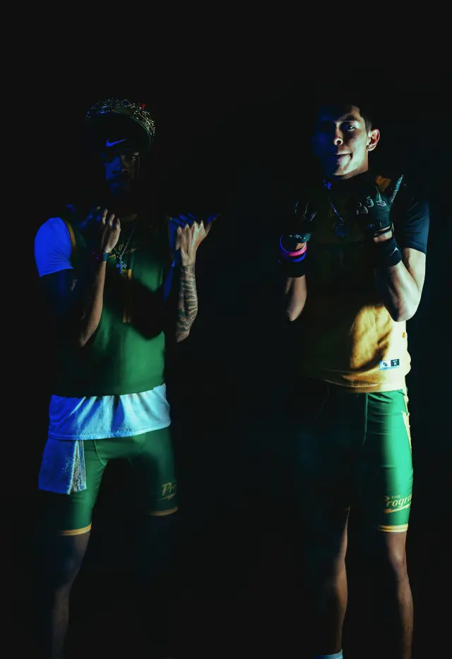 Program athlete number 7 in gold pointing at the camera